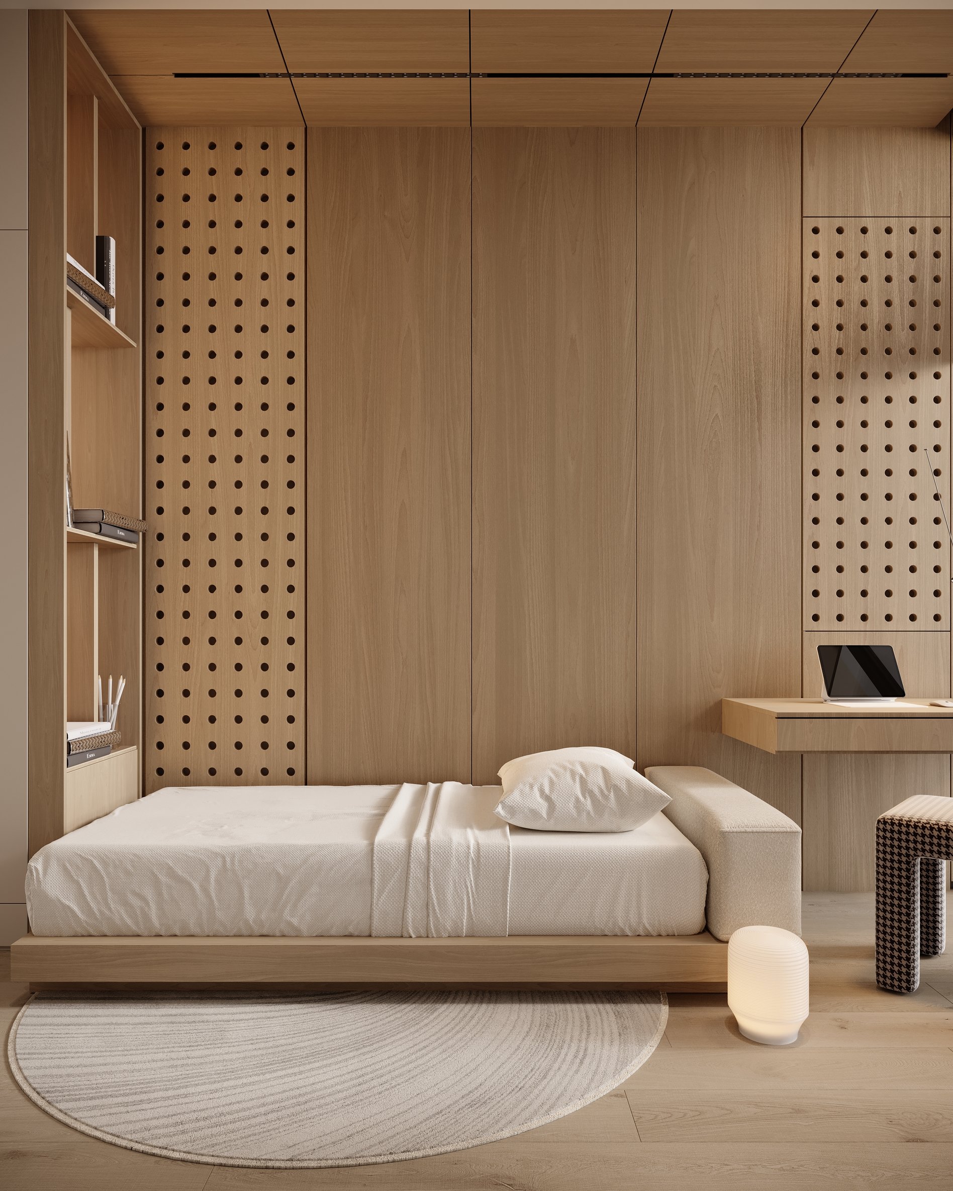 Guest bedroom featuring perforated wooden panels, built-in desk, and custom storage solutions.