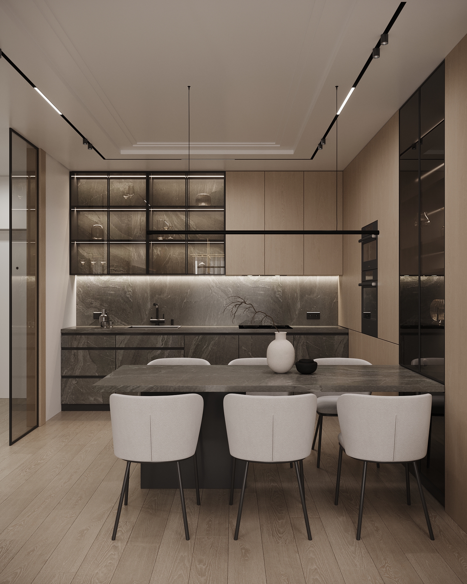 Modern kitchen and dining area with grey stone countertops, glass display cabinets, and white dining chairs.
