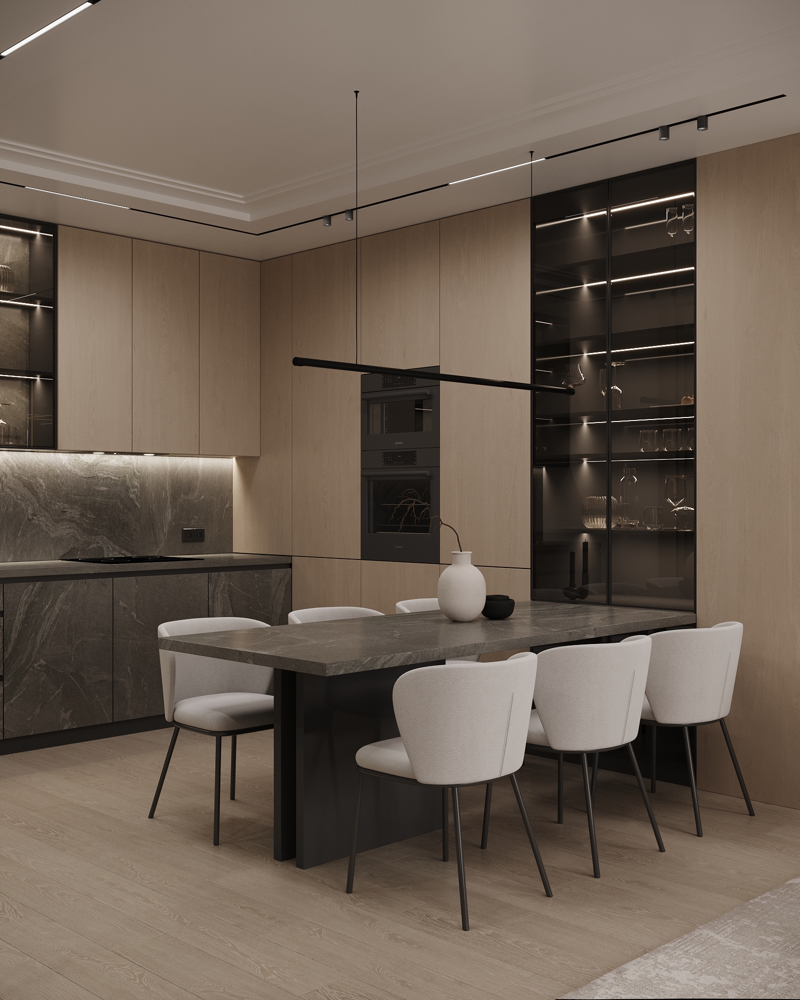 Contemporary kitchen featuring built-in appliances, stone countertops, and dining area with white upholstered chairs.