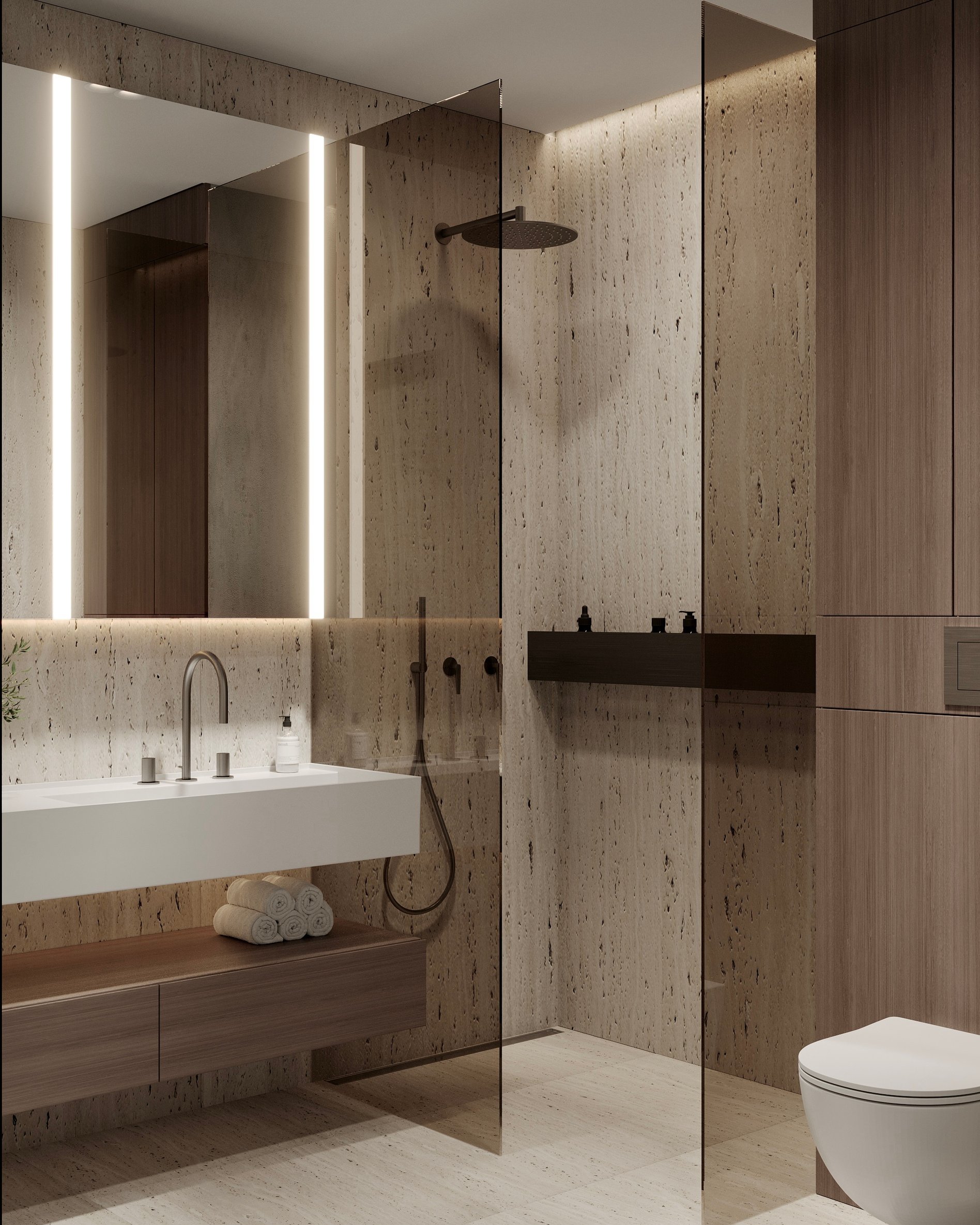 Modern bathroom featuring travertine walls, floating vanity with integrated lighting, and glass-enclosed shower with matte black fixtures.