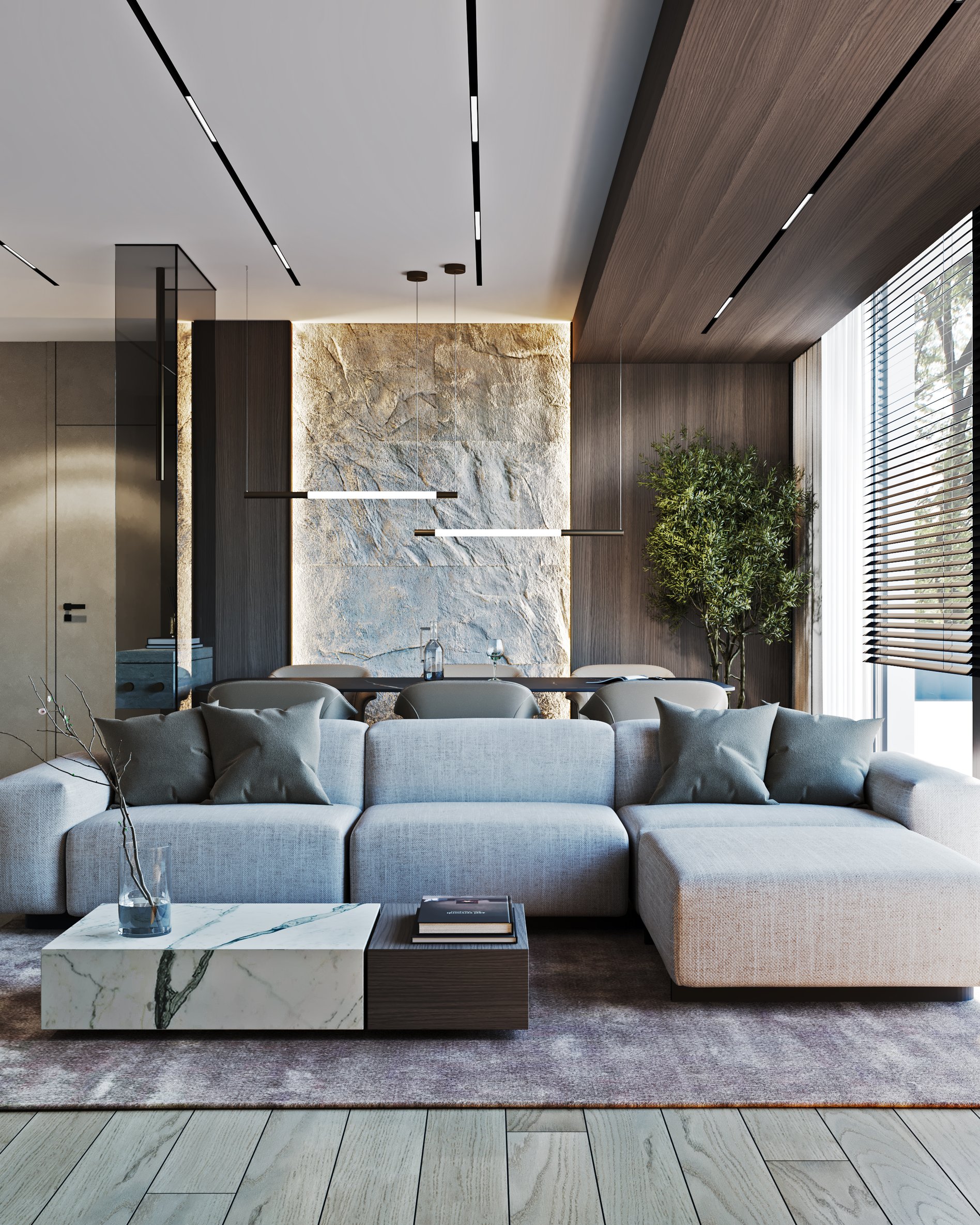 Living room with sectional sofa, illuminated textured stone wall, and linear pendant lighting.