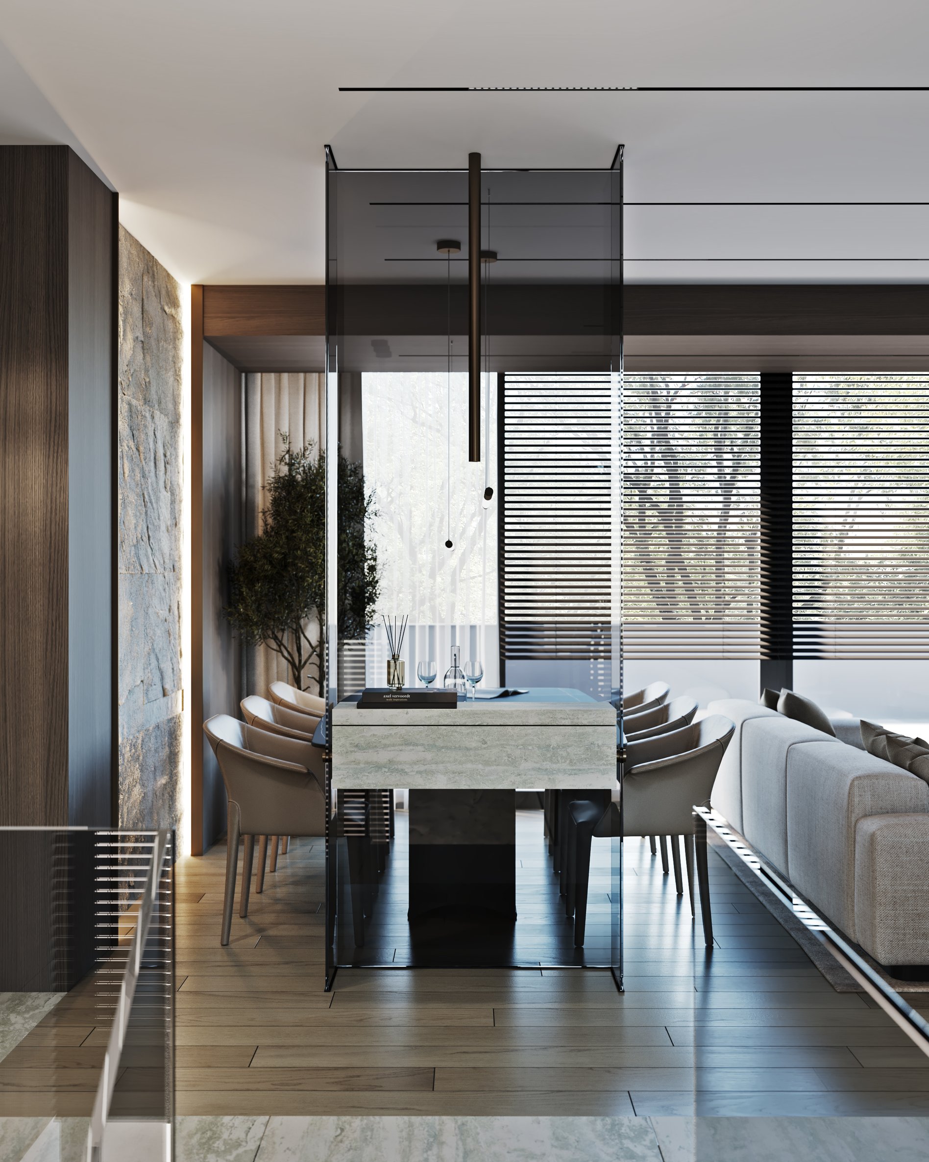 Elegant dining space with indoor olive tree, glass room divider, and contemporary furniture.