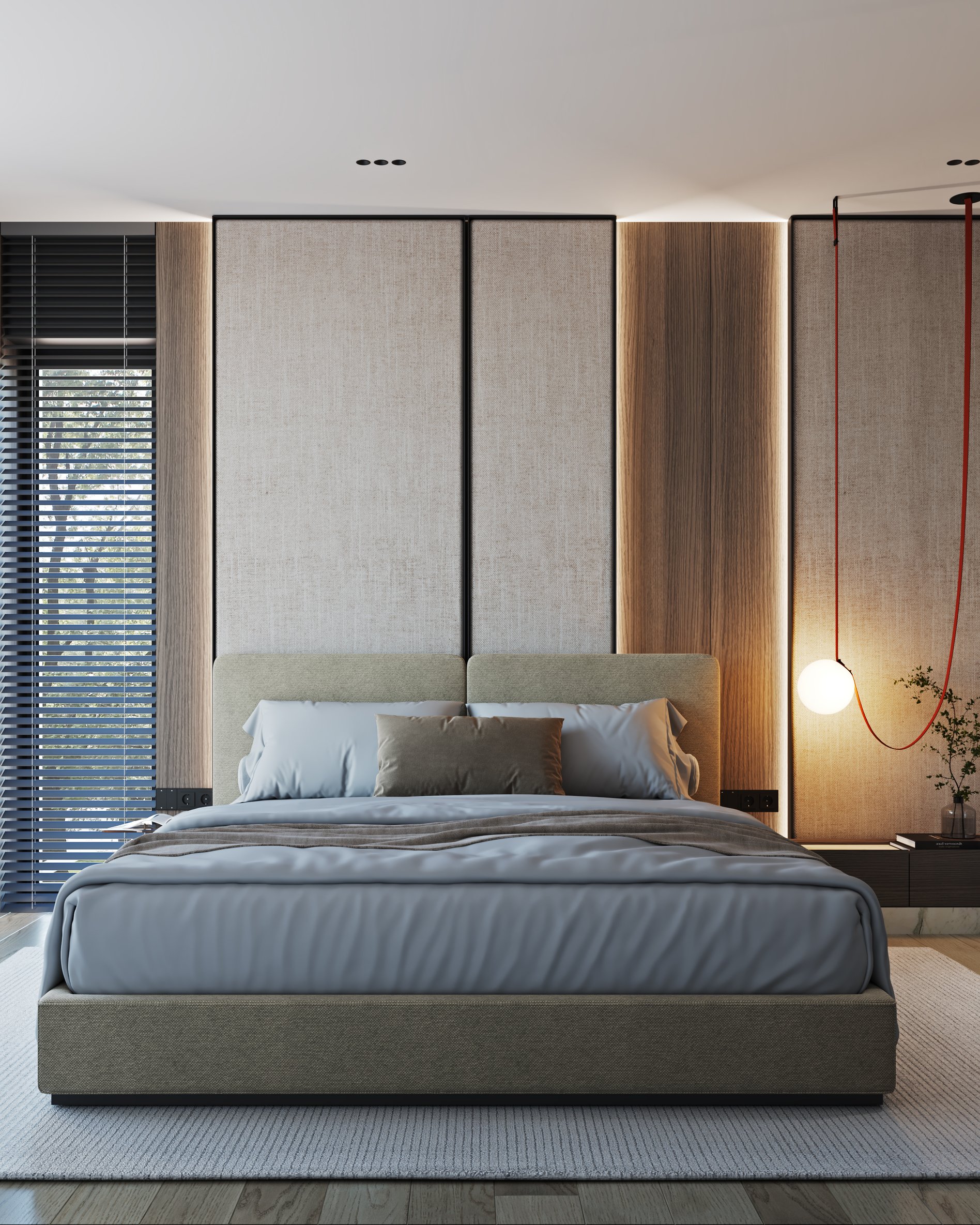 Contemporary master bedroom with upholstered headboard wall, red pendant light, and wooden accent panels.