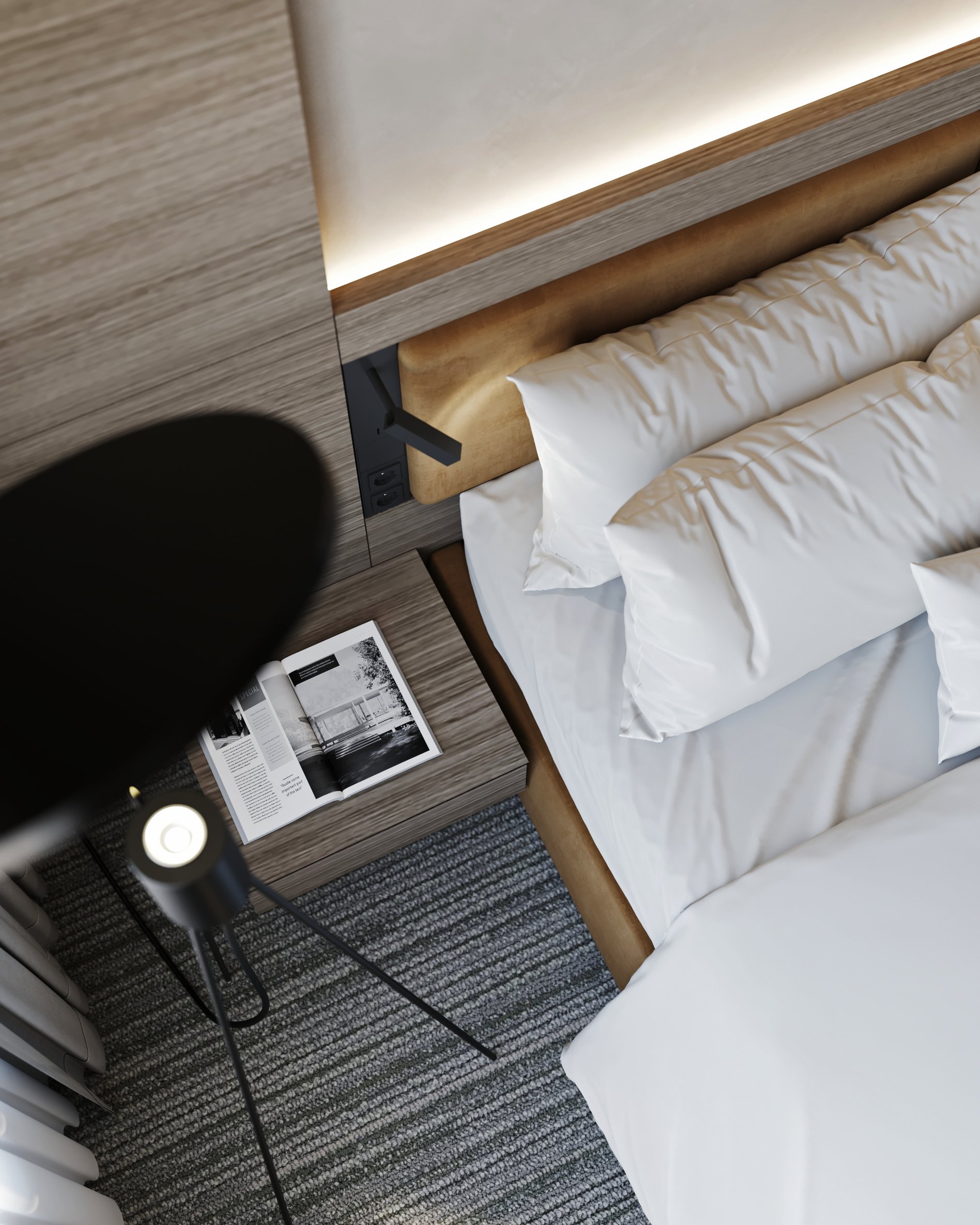 Detailed view of hotel room bedside area with custom lighting and wooden wall panels.