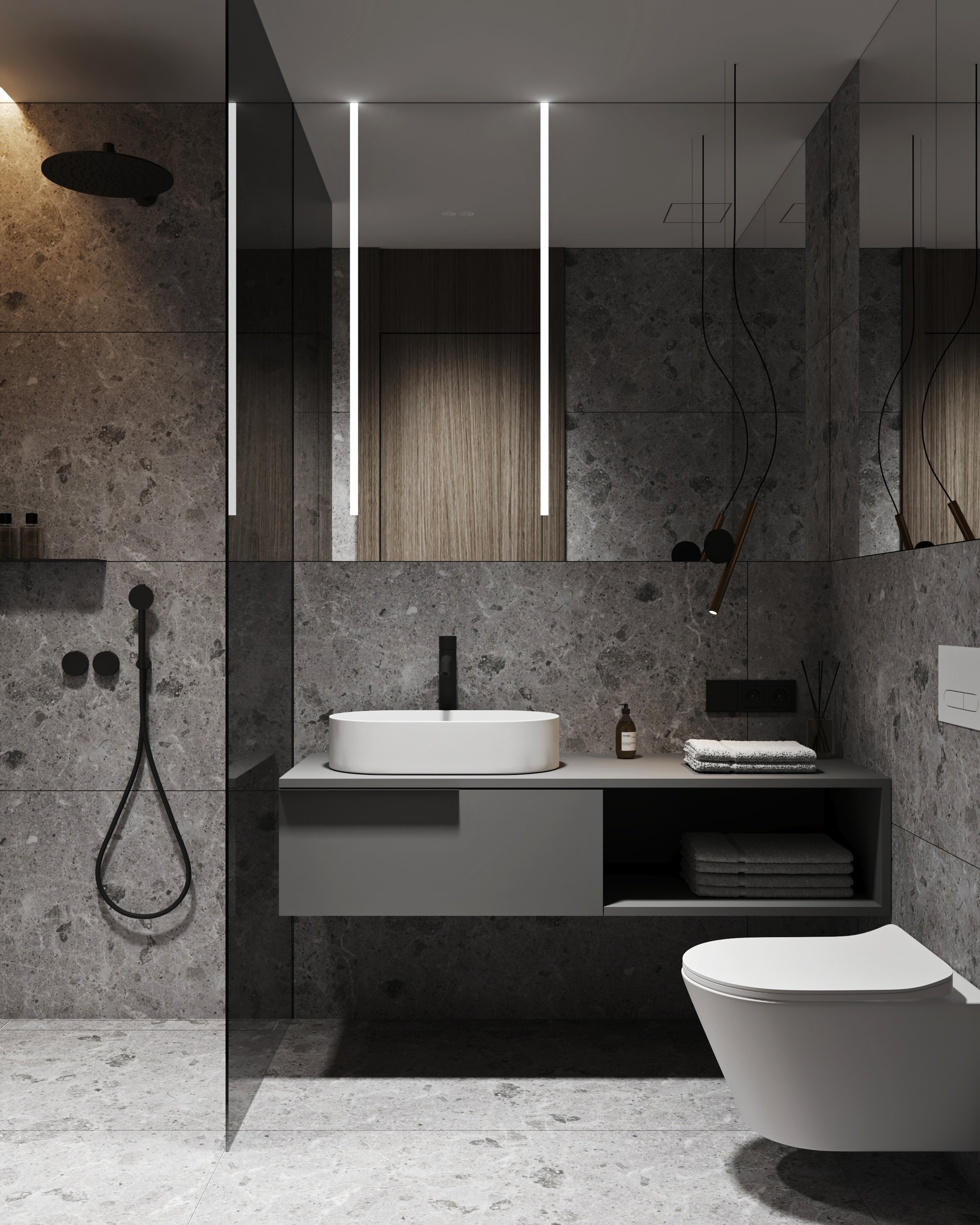 Modern hotel bathroom with dark terrazzo walls, floating vanity, and matte black fixtures.