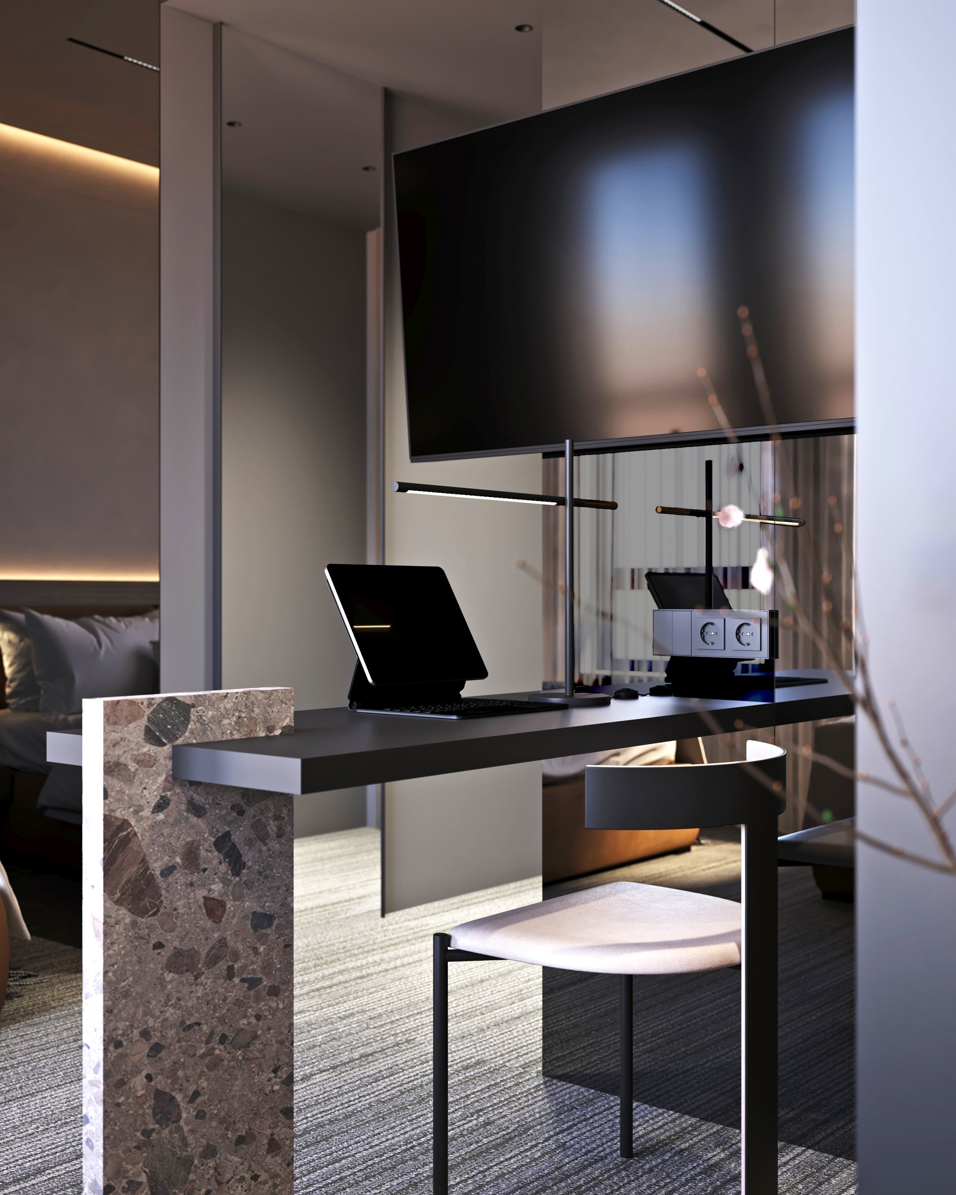 Hotel room workspace with wall-mounted TV, integrated desk lighting, and terrazzo accents.