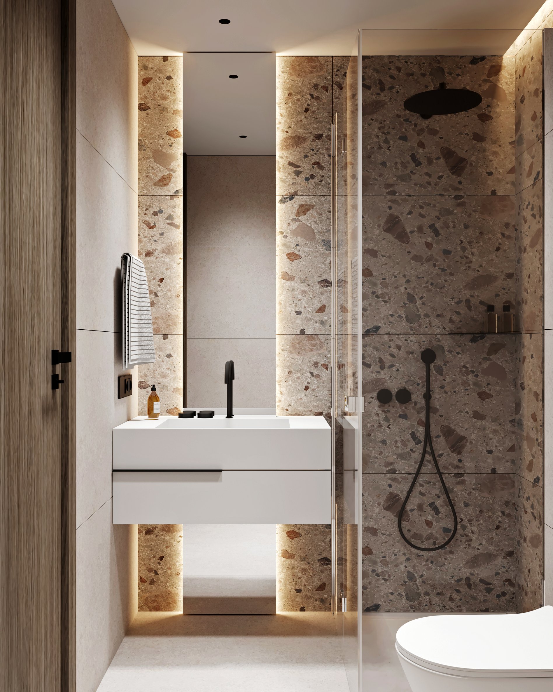 Bright hotel bathroom with backlit terrazzo panels, floating vanity, and glass shower enclosure.