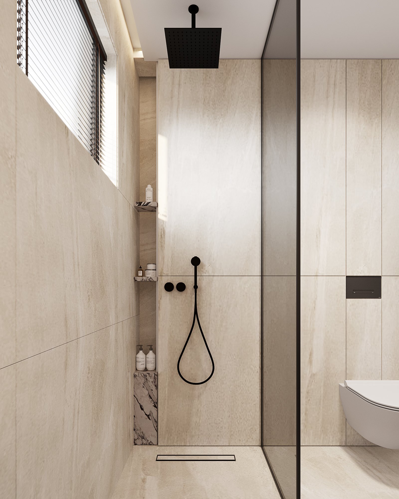 Contemporary shower room with cream stone walls, built-in shelving, black fixtures and glass partition.