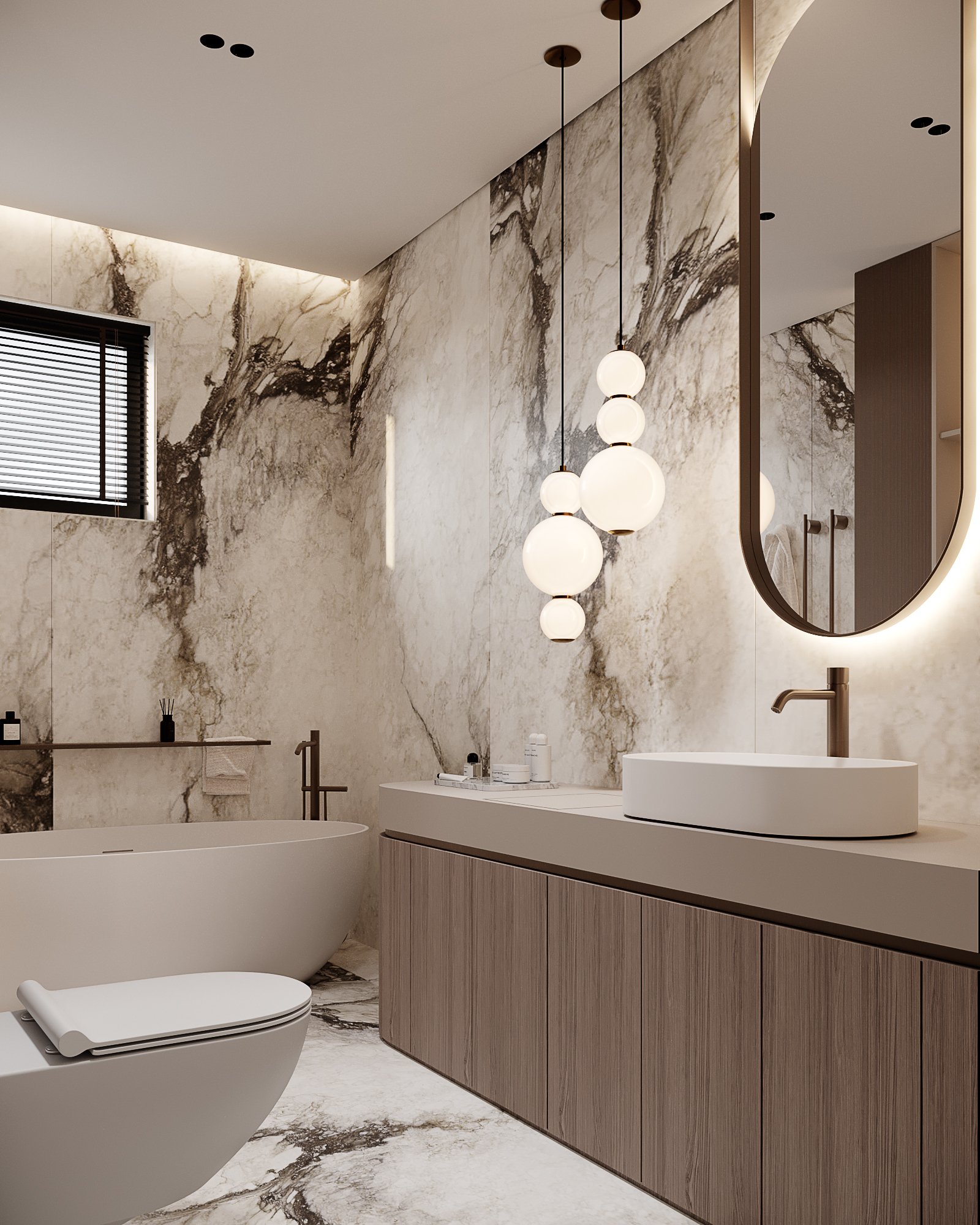 Detailed view of bathroom with marble walls, oval mirror, wooden cabinetry and designer pendant lights.