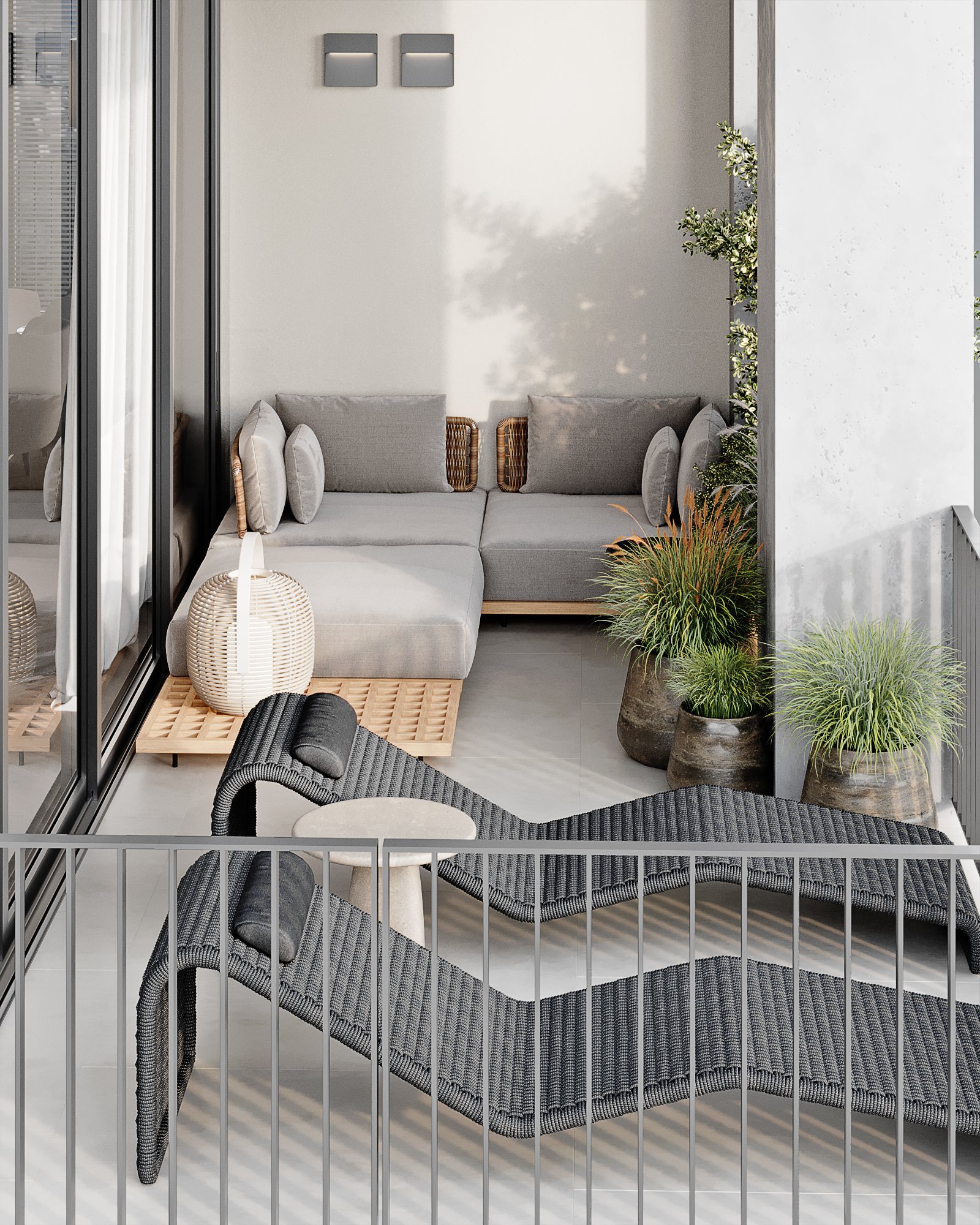 Modern terrace lounge area featuring a grey modular sofa, woven lantern, and sculptural outdoor chaise with ornamental grasses.