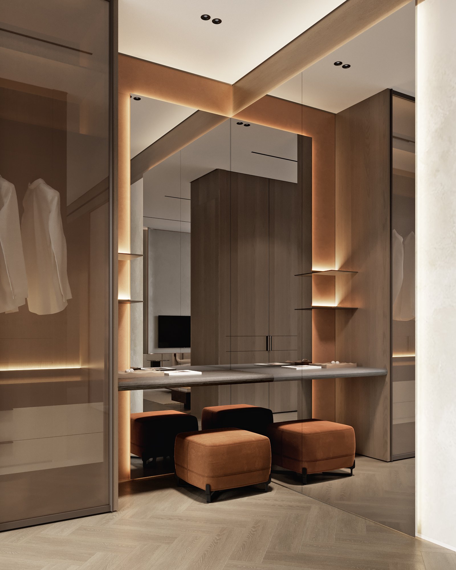 Sophisticated dressing room with illuminated mirrors, built-in storage, and terracotta ottomans.