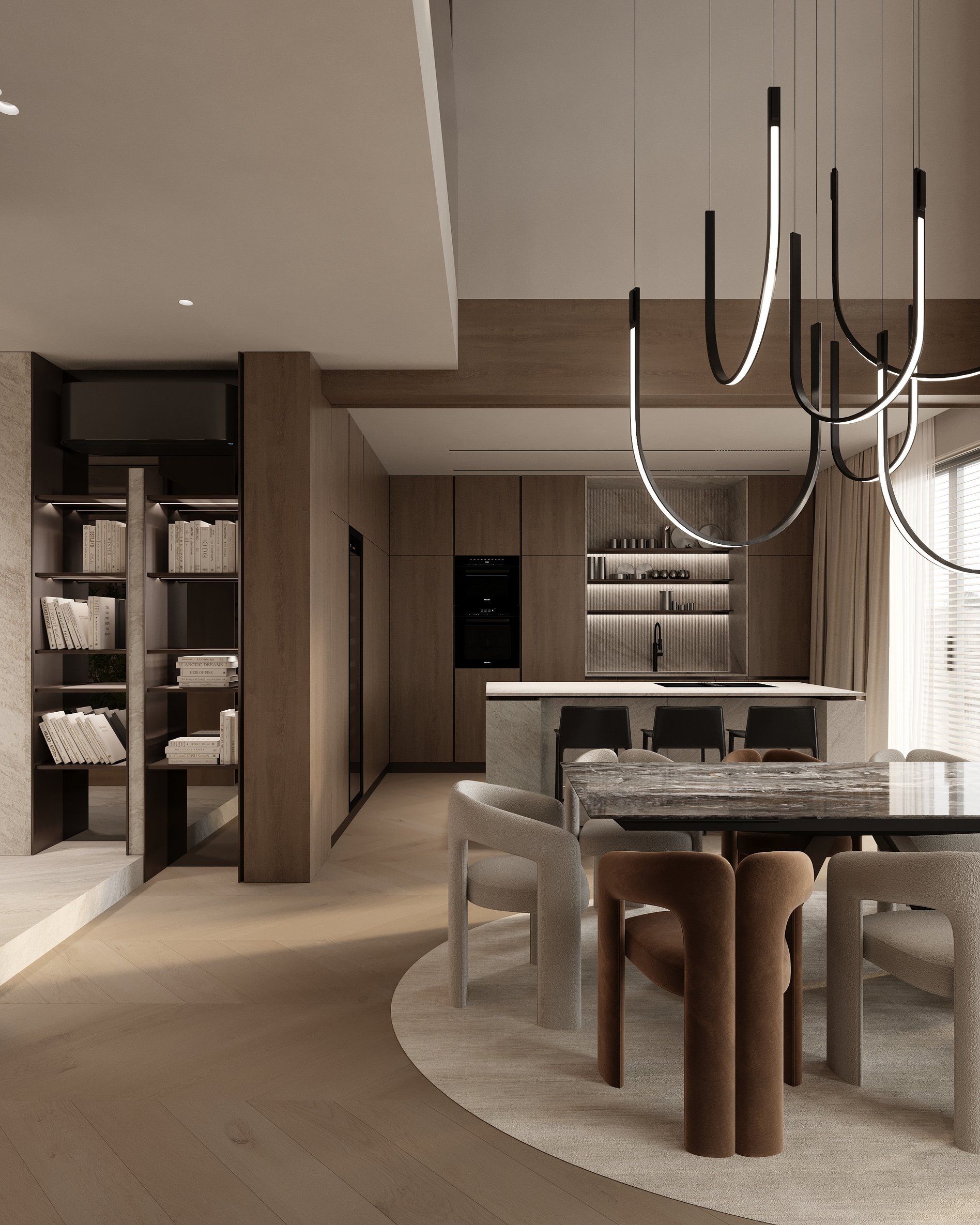 Open dining and kitchen area with sculptural dining chairs, dramatic pendant lights, stone kitchen island, and built-in shelving with books.