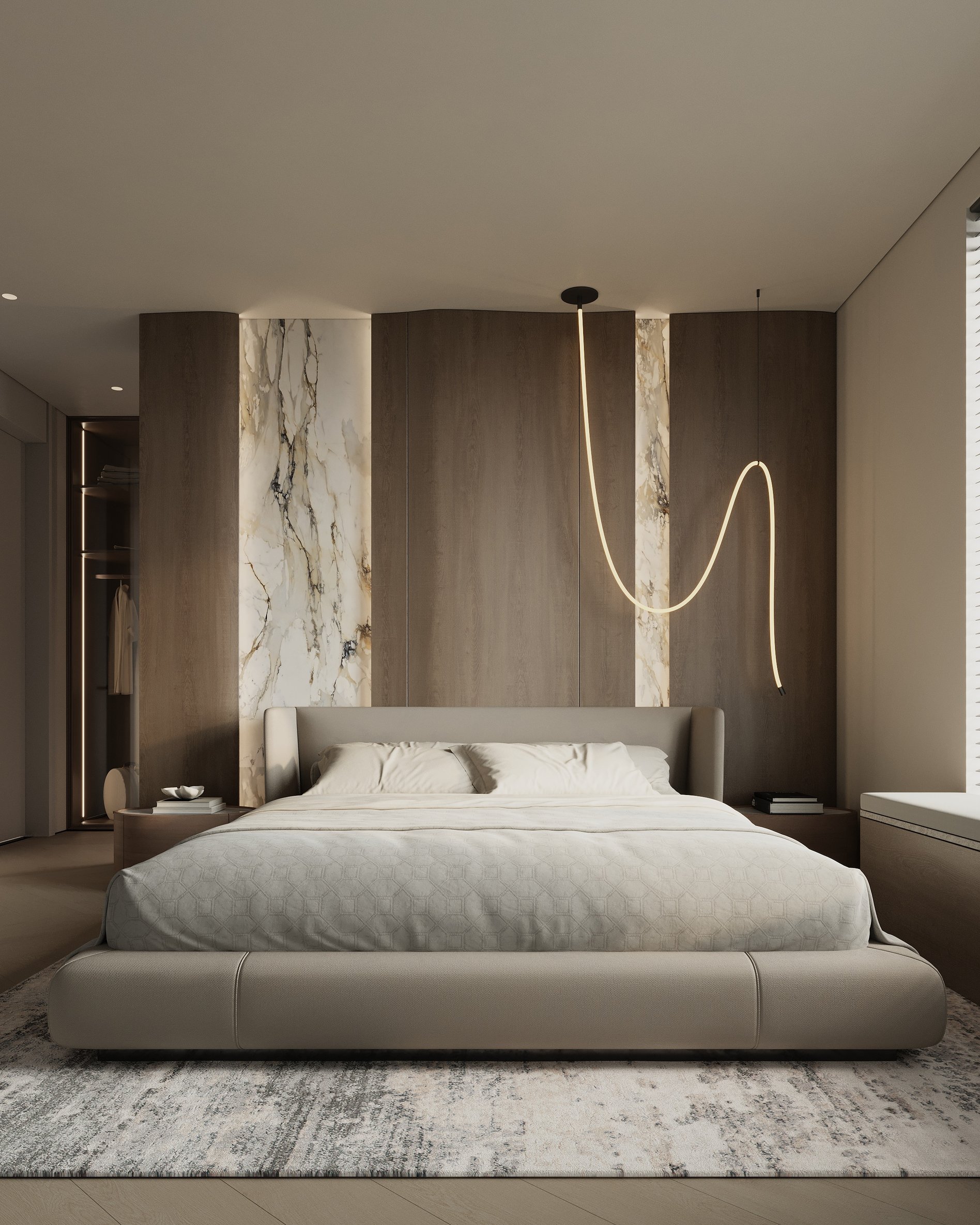 Serene master bedroom with upholstered bed, sculptural pendant light, wood panel accent wall, and marble vertical insets.