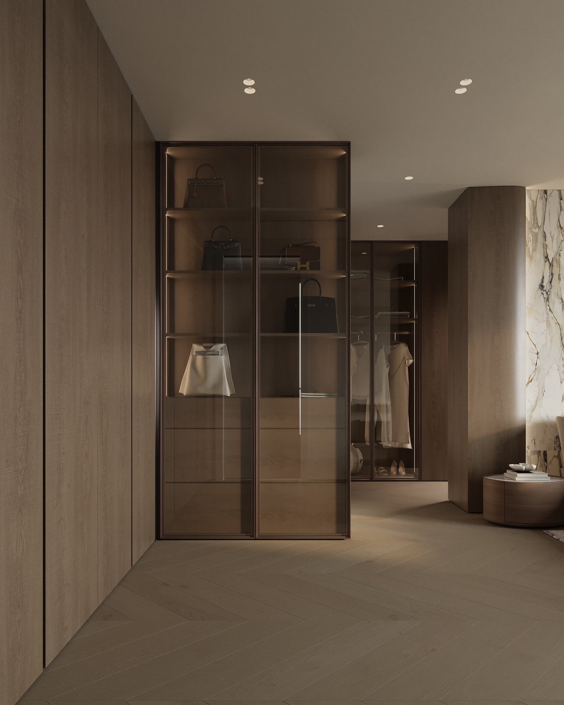Luxury walk-in closet with glass-front wardrobes, integrated lighting, and open shelves for bags and clothing.