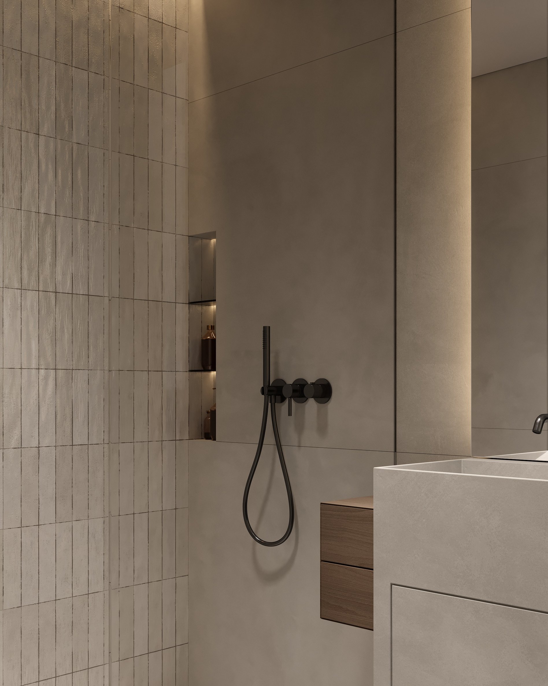 Bathroom shower area with built-in niche, matte black fixtures, and large-format stone tiles.