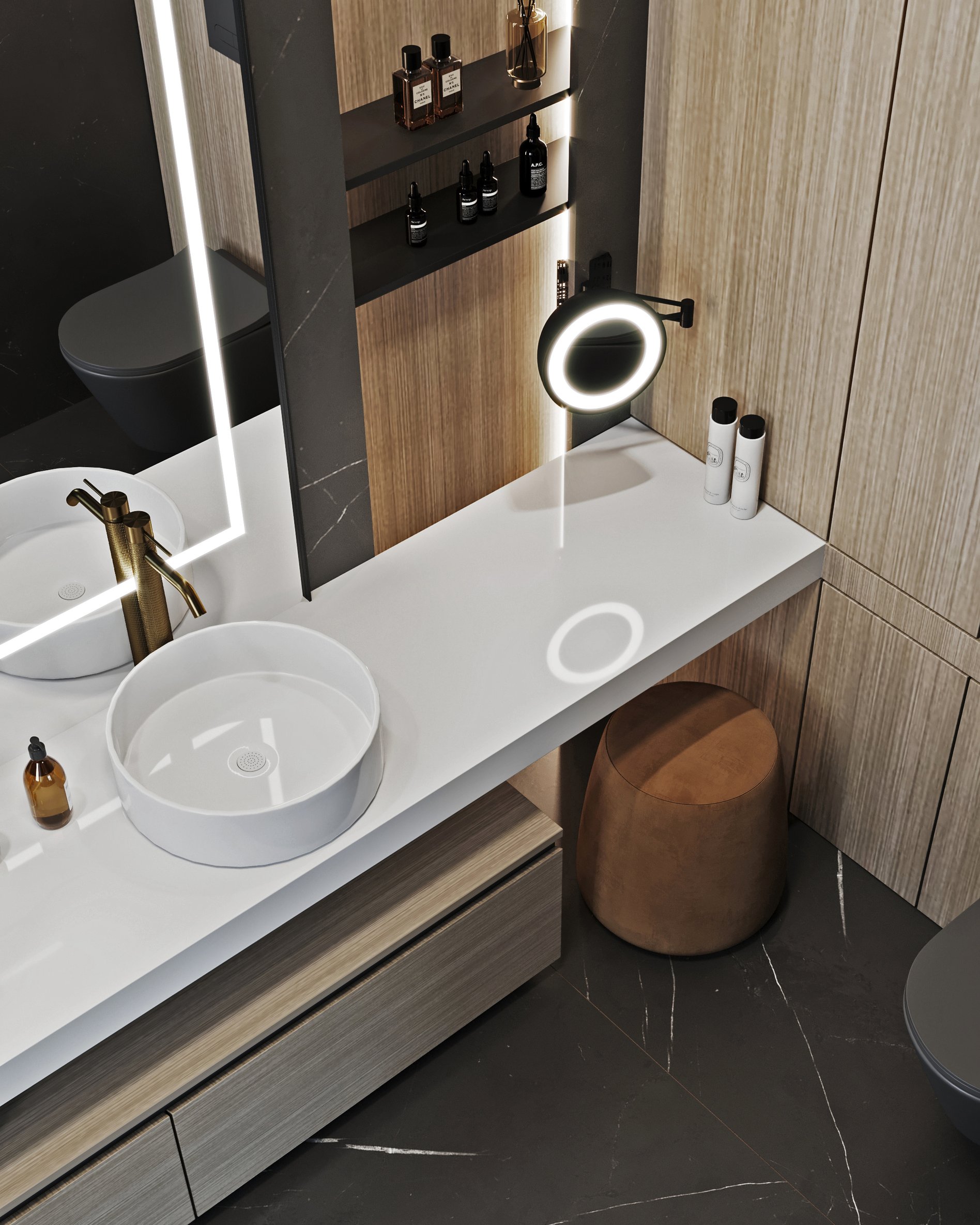 Detailed view of bathroom vanity with white vessel sink, brass faucet, illuminated magnifying mirror and built-in shelving for toiletries.
