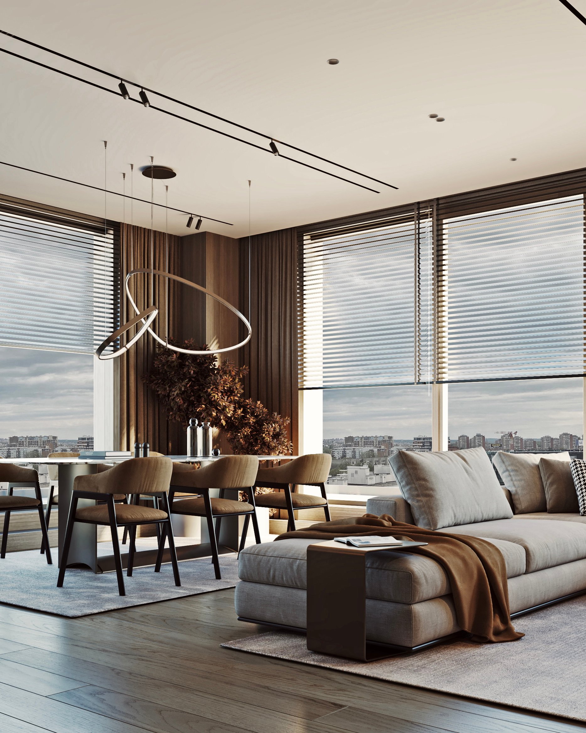 Contemporary open-plan living space with floor-to-ceiling windows, grey sectional sofa, and marble dining table.