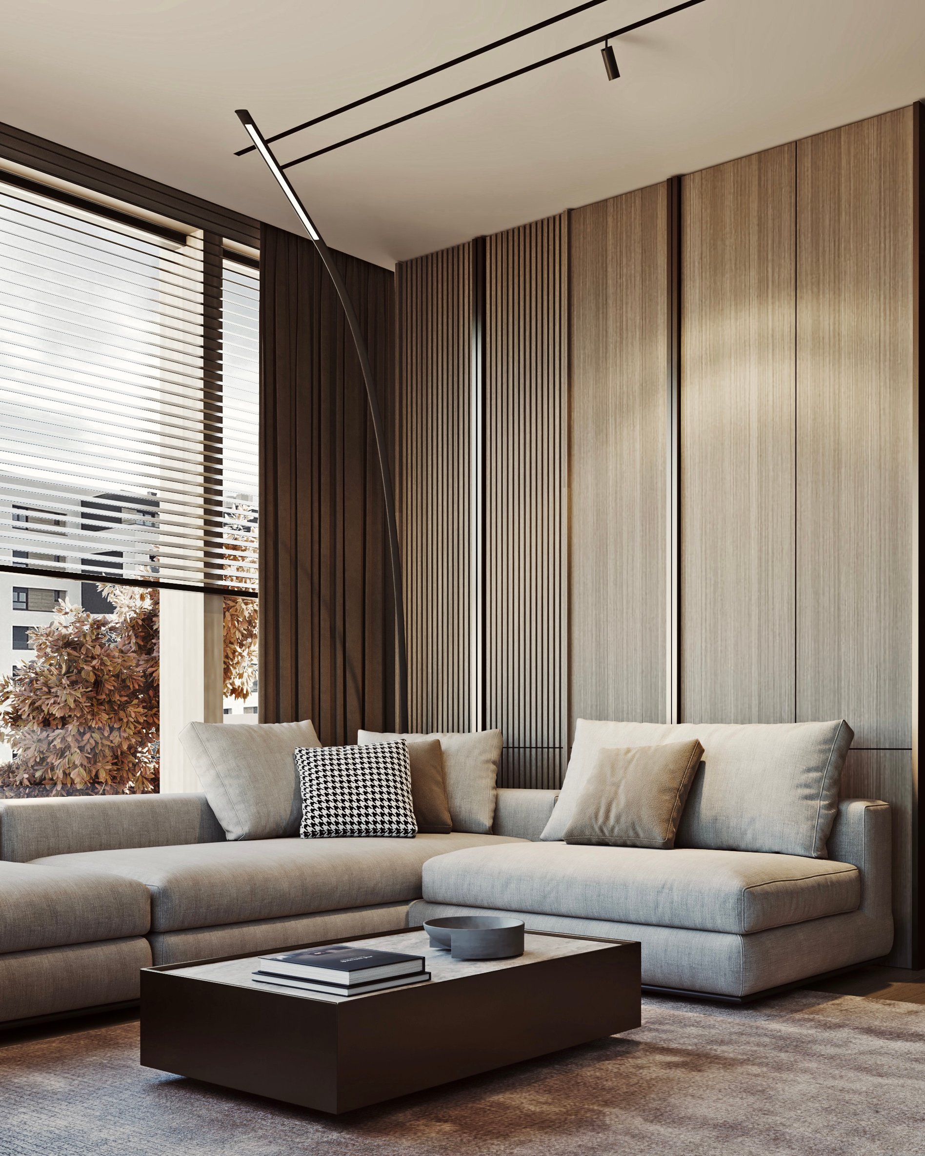 Modern living room with grey sectional sofa, houndstooth pillows, and minimalist coffee table.