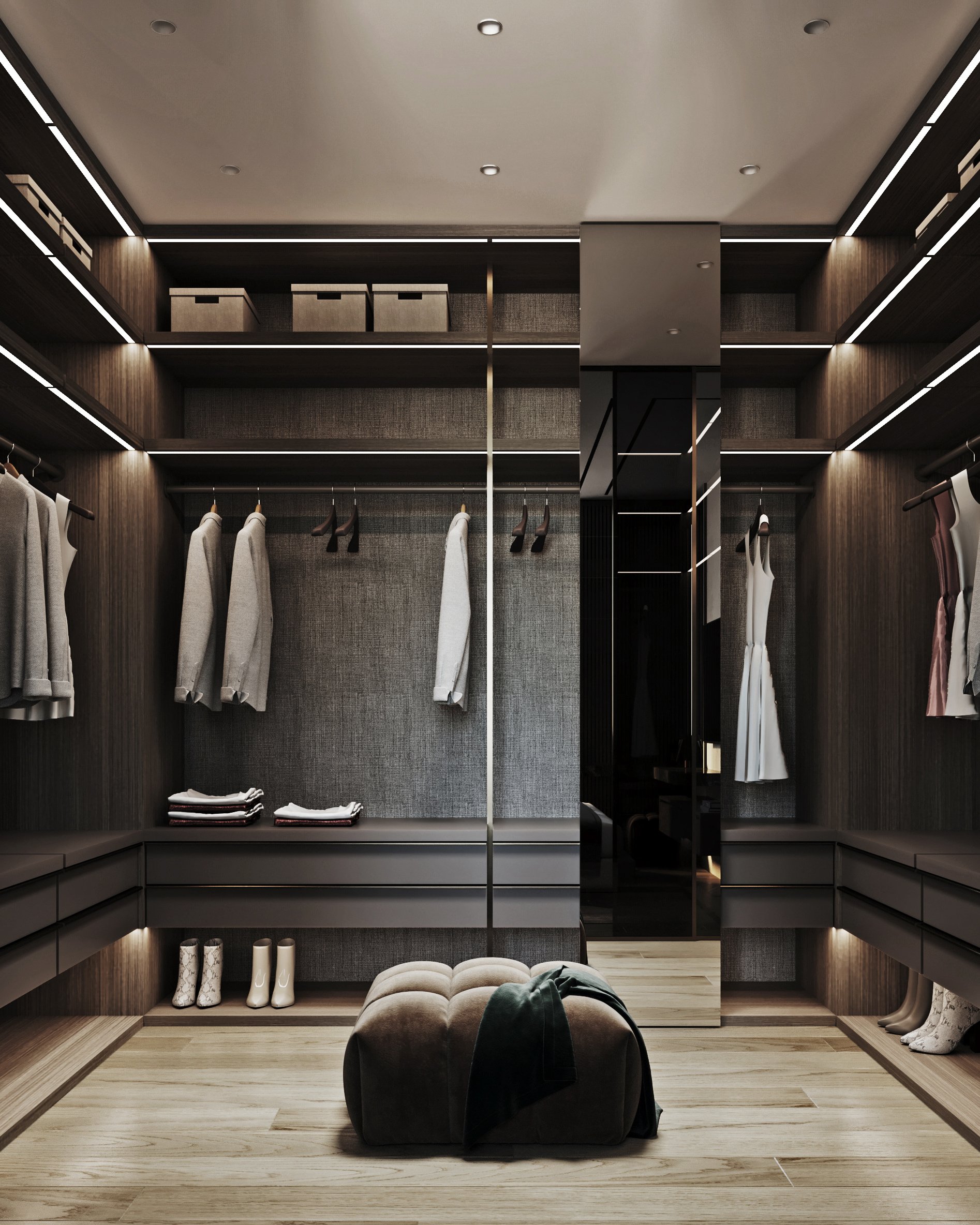Modern walk-in closet with LED lighting, grey textile wall panels, built-in storage, and tufted ottoman.