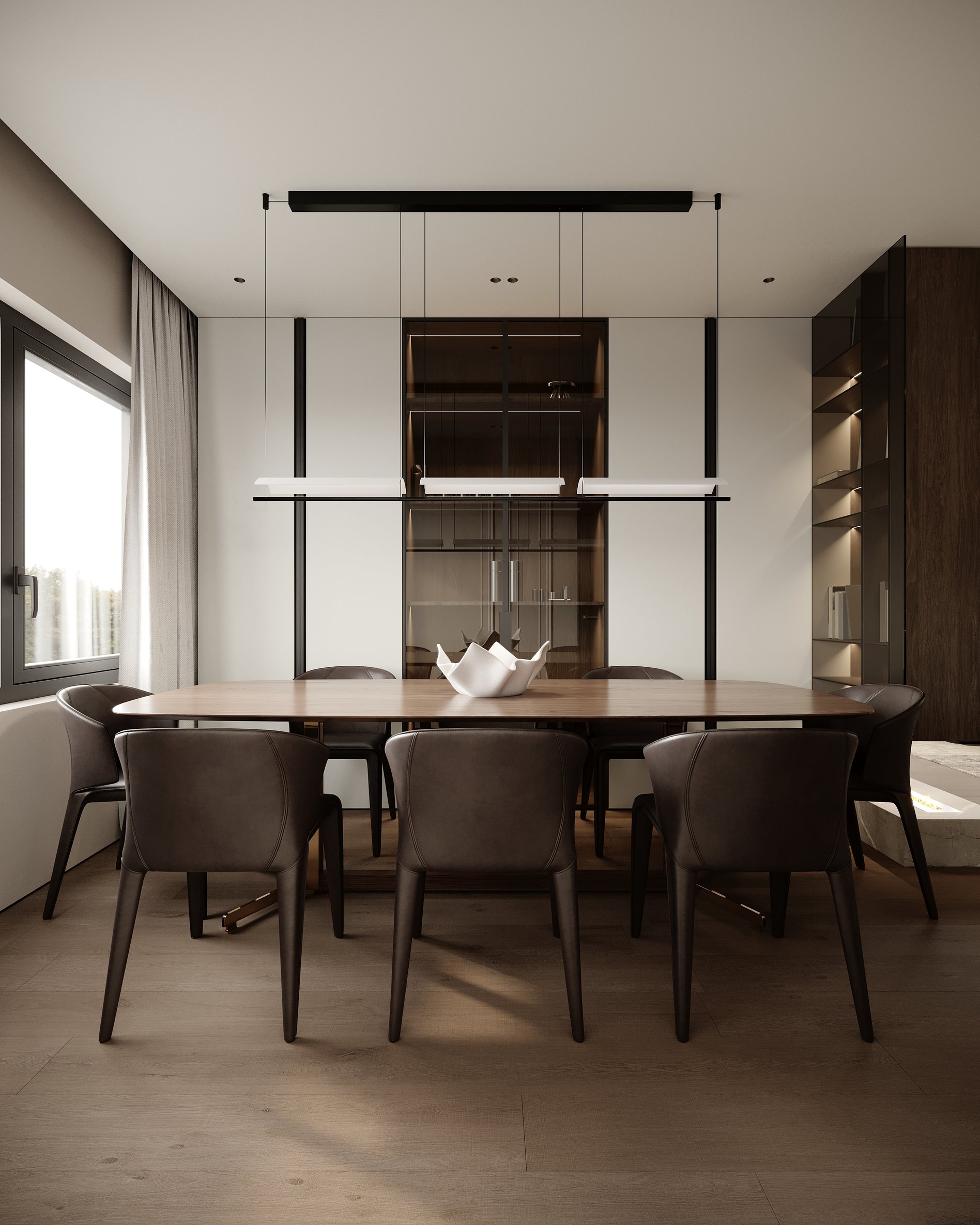 Contemporary dining area with wooden table, black upholstered chairs, and suspended black lighting system.