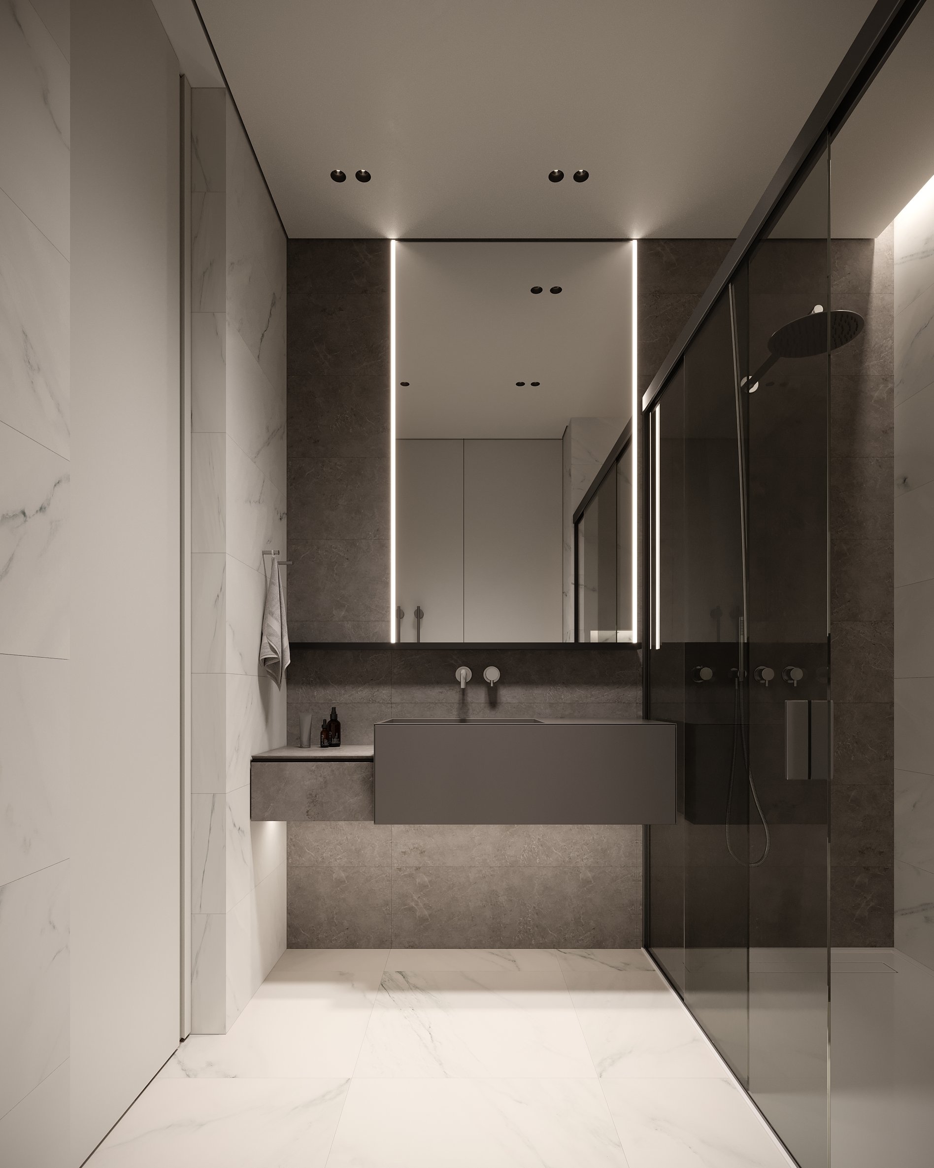 Contemporary bathroom featuring a floating dark grey vanity, LED-illuminated mirror, marble floors and walls, and frameless glass shower enclosure.