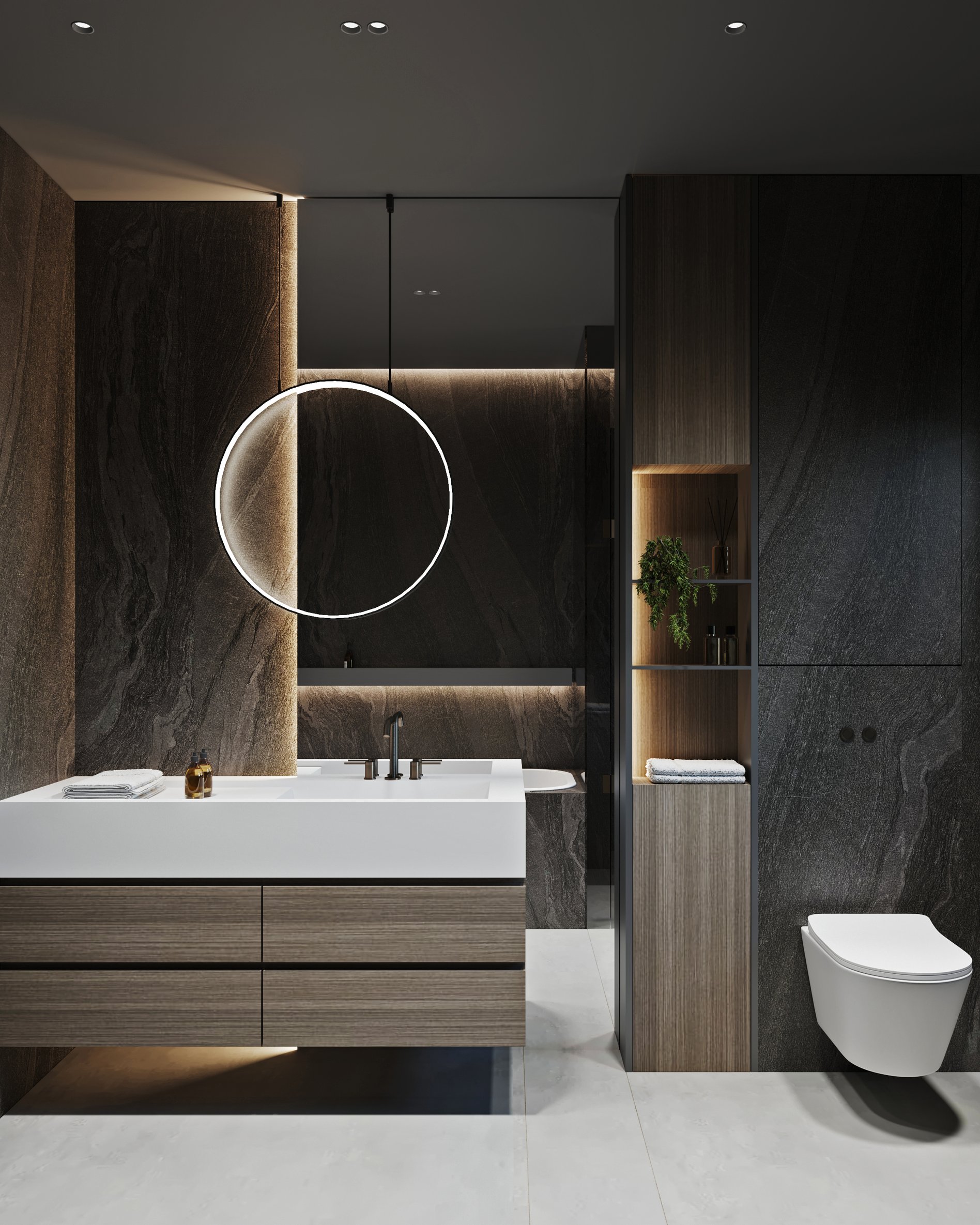 Modern bathroom featuring a circular LED mirror, floating wooden vanity, and dark marble walls with ambient lighting.