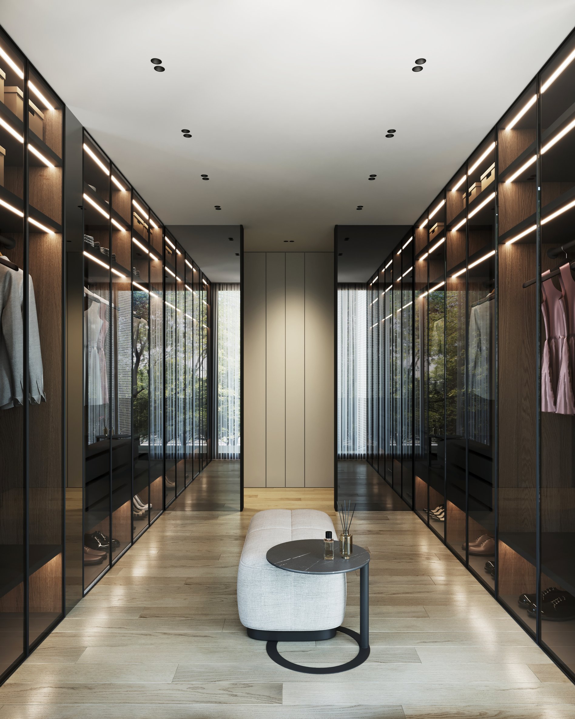 Luxury walk-in closet with glass-fronted wardrobes, LED lighting, and central seating island.