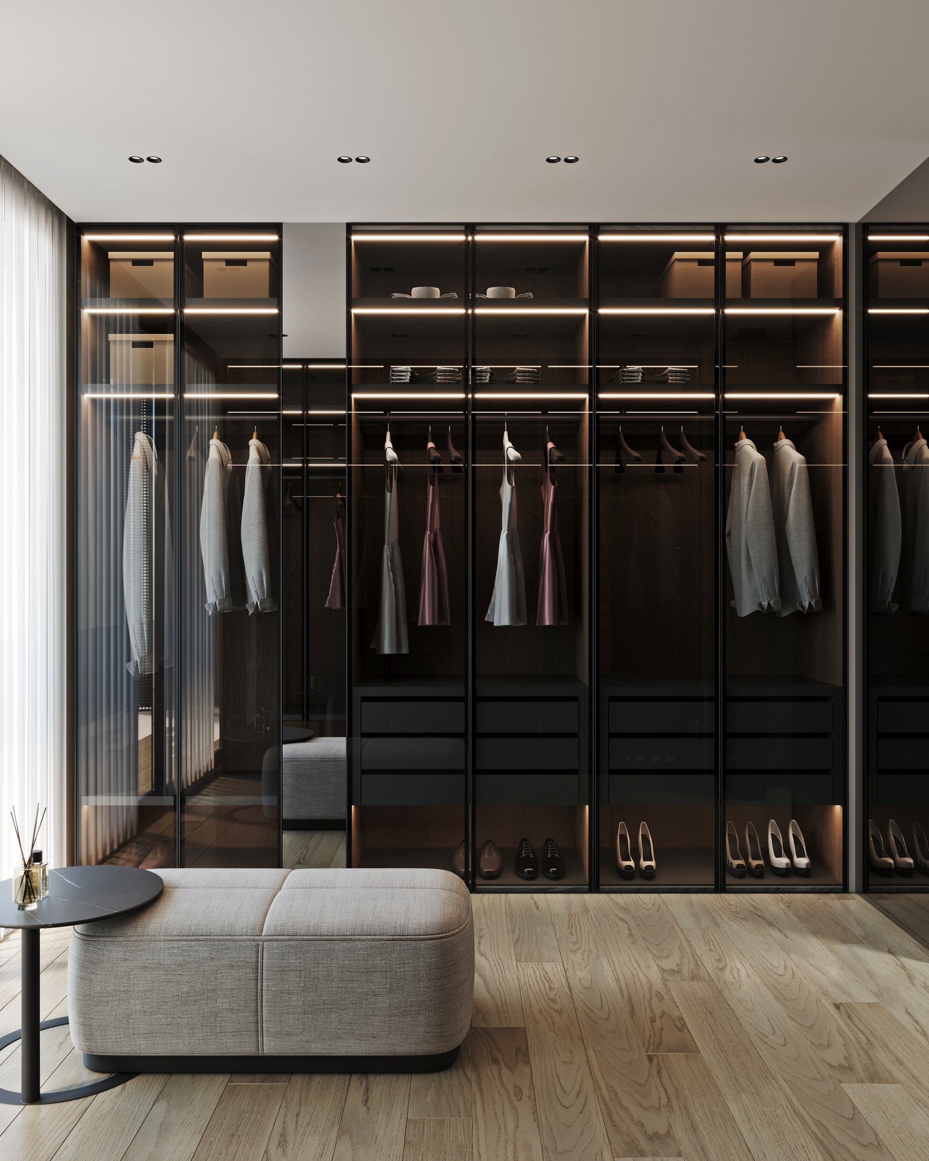 Modern wardrobe with illuminated glass display cases, organized storage, and upholstered ottoman.