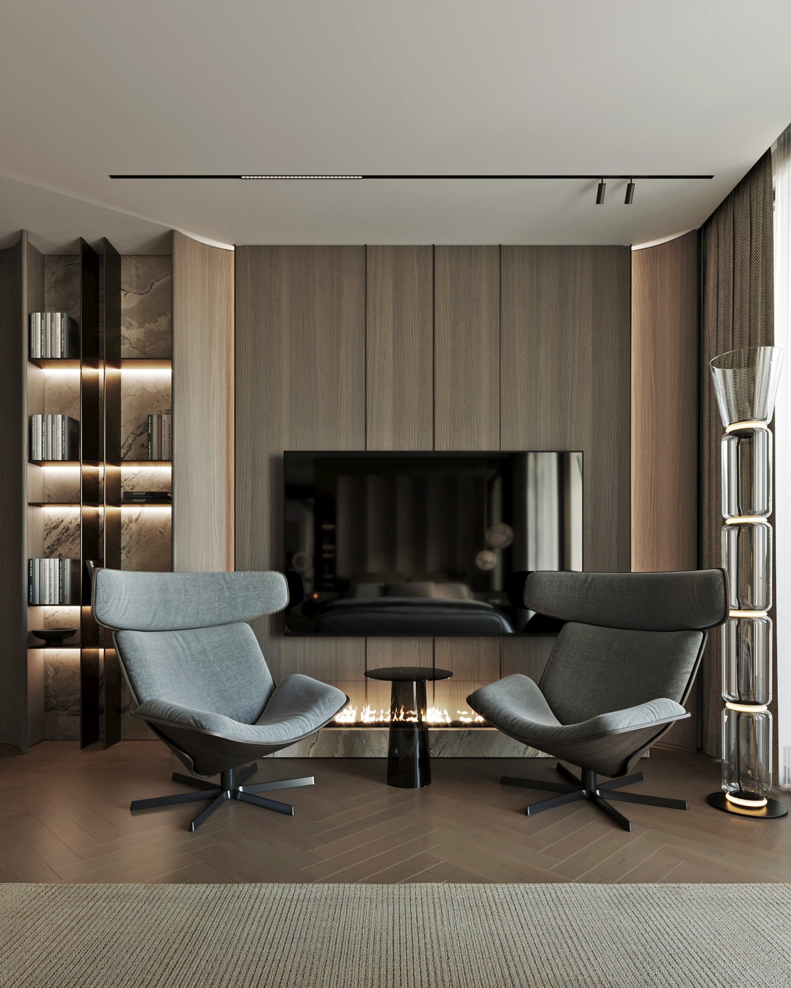 Master bedroom seating area with two designer lounge chairs, built-in fireplace, and illuminated bookshelves.
