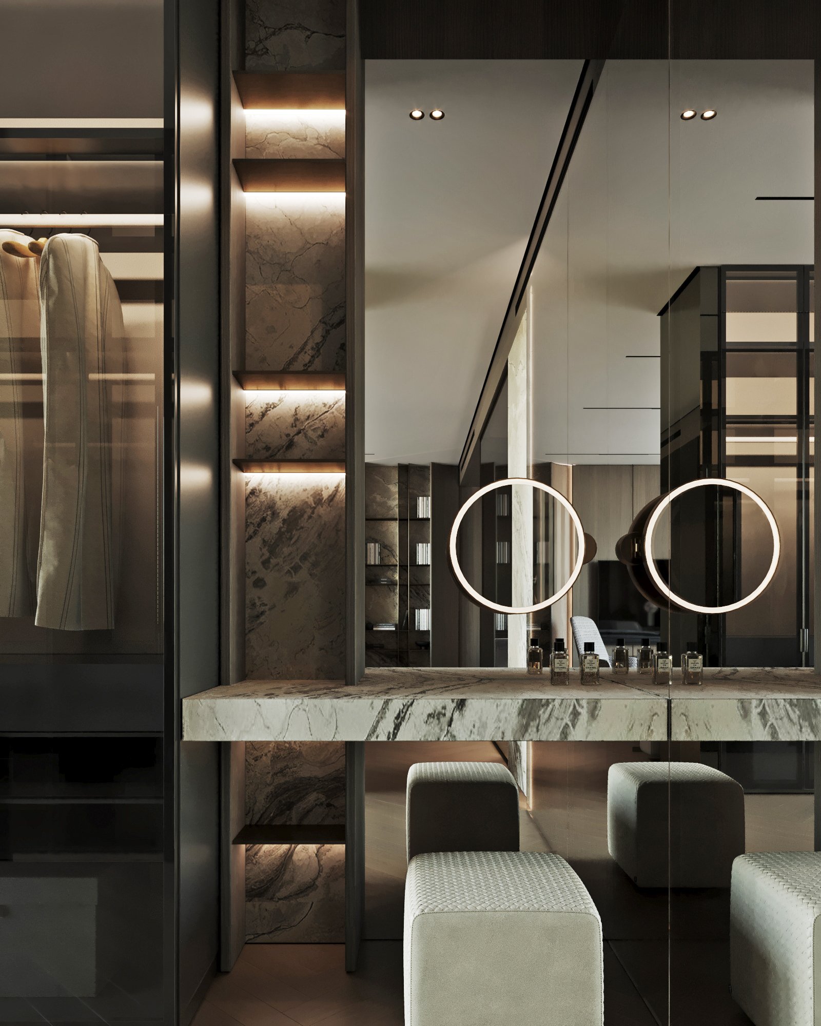 Master dressing area with marble vanity counter, illuminated circular mirrors, and built-in storage.