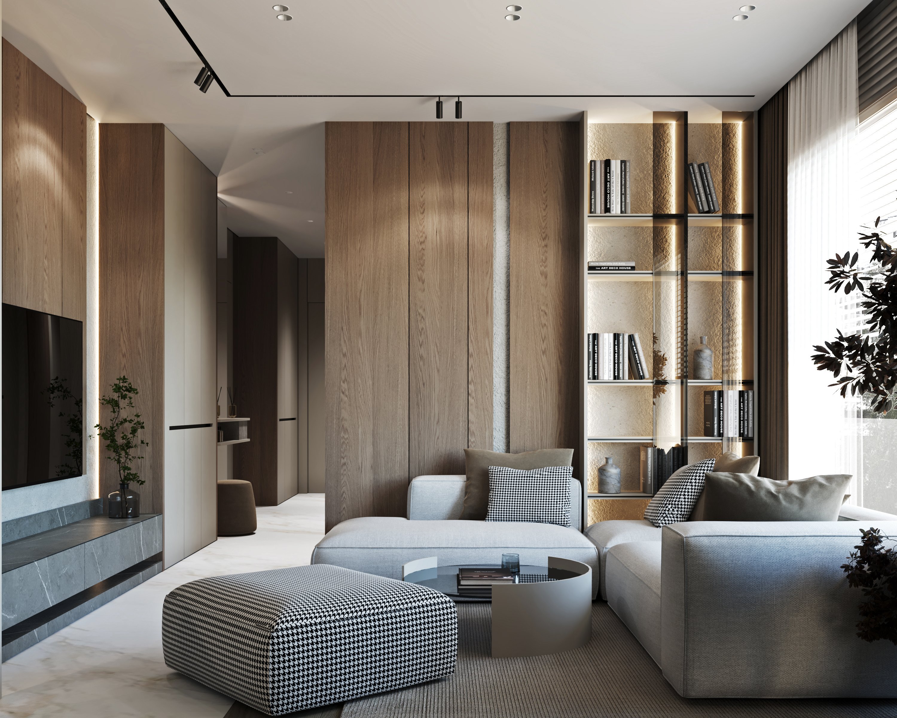 Modern living room featuring oak wood panels, illuminated shelving, and a light grey sectional sofa with houndstooth ottoman.