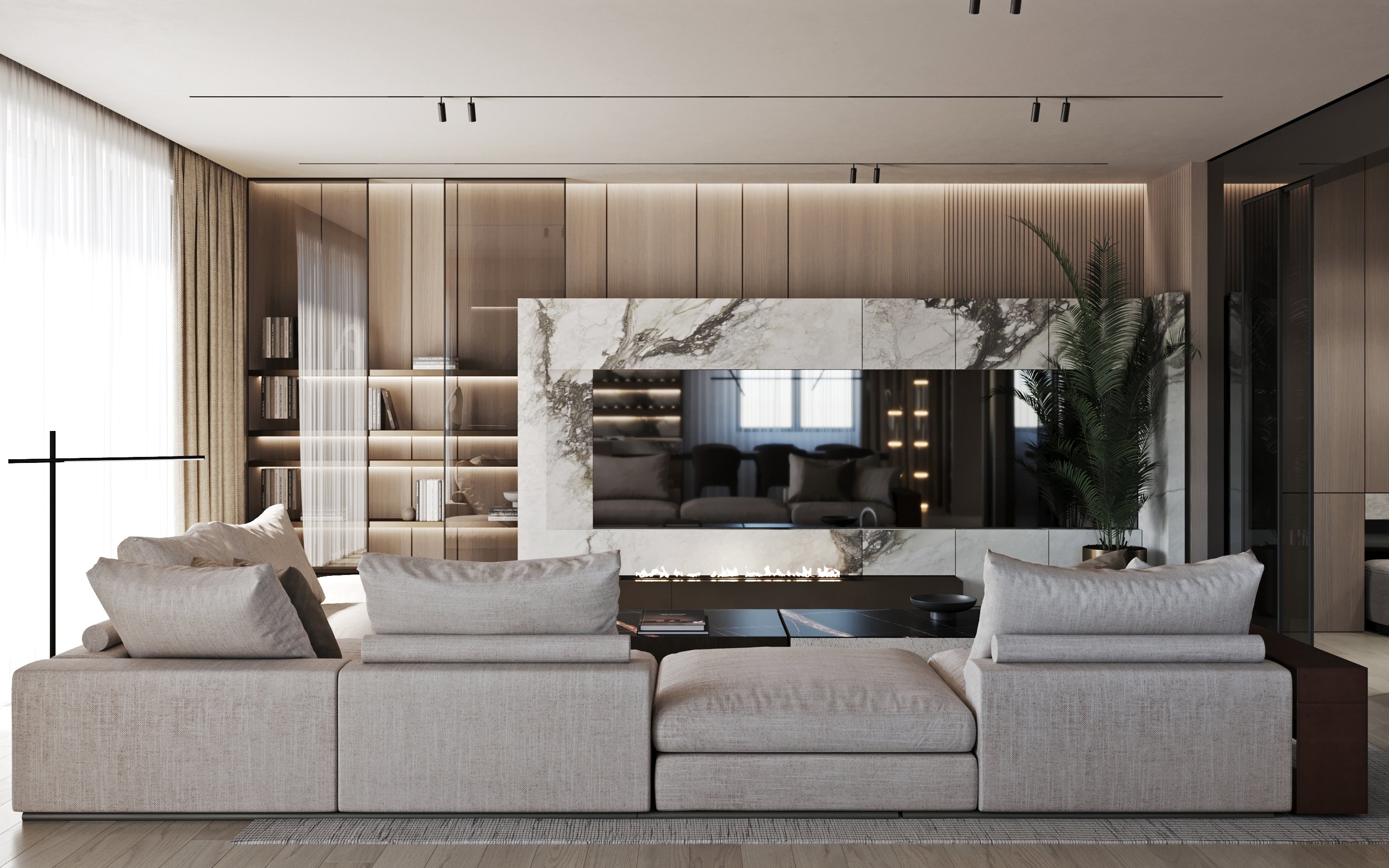 Modern living room featuring a sectional sofa, marble fireplace wall with integrated TV, and built-in illuminated shelving.